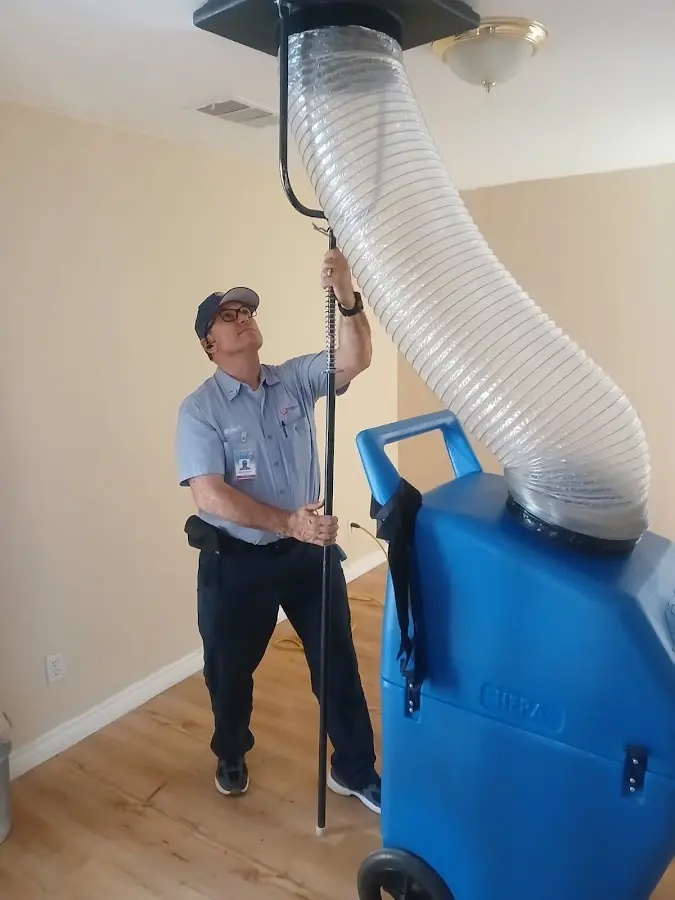 Furnace Tune-Up technician using HEPA equipment in Chico